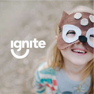 Ignite Afterschool - showing a child smiling, wearing a mask, with Ignite logo